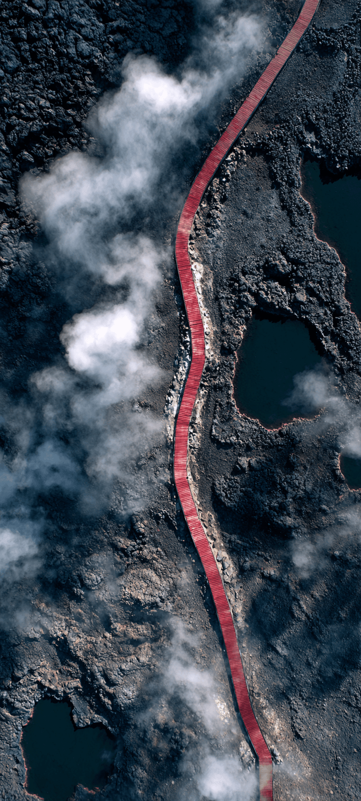 Red Boardwalk Through Dark Volcanic Landscape — Aerial Wallpaper